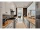 Kitchen featuring stone countertops, stainless steel appliances, and an open doorway at 32 Prioleau St # J, Charleston, SC 29401