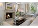 Cozy living room with a fireplace, elegant decor, and neutral tones creating a warm and inviting atmosphere at 32 Prioleau St # J, Charleston, SC 29401