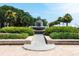 Picturesque view of a pineapple-shaped fountain surrounded by lush greenery and flowers at 32 Prioleau St # J, Charleston, SC 29401