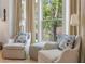 Charming sitting area with comfortable chairs, decorative pillows, and bright natural light at 32 Prioleau St # J, Charleston, SC 29401