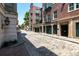 Brick-paved street view of building exteriors with storefronts and greenery at 32 Prioleau St # J, Charleston, SC 29401
