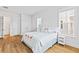 Airy bedroom features a flamingo-themed bedspread, light-colored wood floors, and two large windows at 325 Blowing Fresh Dr, Charleston, SC 29492