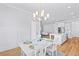 Bright dining area adjacent to kitchen, featuring modern lighting and comfortable seating for four at 325 Blowing Fresh Dr, Charleston, SC 29492