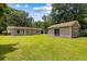 Spacious backyard featuring a well-maintained lawn, a detached garage and an attached building at 3347 Walter Drive, Johns Island, SC 29455