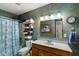 Charming bathroom featuring patterned wallpaper, a framed mirror, and shower with a blue patterned curtain at 3347 Walter Drive, Johns Island, SC 29455