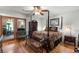 Elegant bedroom featuring a four-poster bed, wooden floors, and a mirrored closet for ample storage space at 3347 Walter Drive, Johns Island, SC 29455