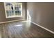 Bright bedroom features a large window and gray wood-look flooring at 3347 Walter Drive, Johns Island, SC 29455