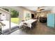 Bright dining room with a large table, sliding glass doors to the backyard, and access to a bar area at 3347 Walter Drive, Johns Island, SC 29455