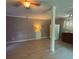 Open-concept living space featuring a modern design with a column, kitchenette, and laminate floors at 3347 Walter Drive, Johns Island, SC 29455