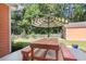 Backyard features a picnic table under an umbrella, shed and a white picket fence at 350 Cypress Walk Way, Wando, SC 29492
