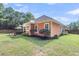 Spacious backyard with a covered patio, outdoor seating, and well-maintained lawn at 350 Cypress Walk Way, Wando, SC 29492