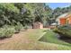 Large, grassy backyard with shed and a fenced perimeter, perfect for privacy and outdoor activities at 350 Cypress Walk Way, Wando, SC 29492