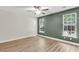 Empty bedroom with large windows, green accent wall, and modern ceiling fan at 350 Cypress Walk Way, Wando, SC 29492