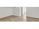 Bright bedroom featuring light wood floors, white walls and trim, and access to a hallway at 350 Cypress Walk Way, Wando, SC 29492