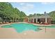 Community pool with a fountain, surrounded by mature trees and tropical plants at 350 Cypress Walk Way, Wando, SC 29492