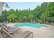 Relaxing community pool area with lounge chairs and lush landscaping at 350 Cypress Walk Way, Wando, SC 29492