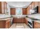 Modern kitchen with stainless steel appliances, wood cabinets, granite countertops and hardwood flooring at 350 Cypress Walk Way, Wando, SC 29492