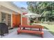 Covered patio with outdoor dining set, grill, and views of the wooded backyard at 350 Cypress Walk Way, Wando, SC 29492