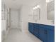 Bathroom featuring double sink with blue cabinets, walk-in shower, modern lighting, and tile flooring at 353 Wappoo Trace Ln, Summerville, SC 29486