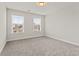 Bright bedroom with neutral walls, carpet, and natural light from two windows at 353 Wappoo Trace Ln, Summerville, SC 29486