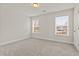 Bright bedroom with neutral walls, carpet, and natural light from two windows at 353 Wappoo Trace Ln, Summerville, SC 29486