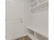 Mudroom with built-in storage bench, shelves, and coat hooks, offers convenient organization near the entrance at 353 Wappoo Trace Ln, Summerville, SC 29486