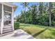 Grassy backyard featuring a screened porch, steps, patio, and a black metal fence at 3537 Crosstrees Ln, Mount Pleasant, SC 29466
