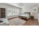 Bright bedroom with large windows, plantation shutters, hardwood floors, and comfortable furniture at 3537 Crosstrees Ln, Mount Pleasant, SC 29466