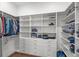 Spacious walk-in closet with custom shelving, drawers, and ample storage space for clothes and accessories at 3537 Crosstrees Ln, Mount Pleasant, SC 29466