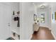 Inviting entryway features hardwood floors, a mudroom with hooks and storage, and a bright front door at 3537 Crosstrees Ln, Mount Pleasant, SC 29466