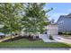Charming home featuring a welcoming porch and attached garage, framed by lush landscaping at 3537 Crosstrees Ln, Mount Pleasant, SC 29466