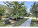Neighborhood street featuring a home framed by trees and landscaping, with sidewalks at 3537 Crosstrees Ln, Mount Pleasant, SC 29466