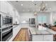 Spacious kitchen featuring white cabinets, a large island, and stainless steel appliances, perfect for cooking and entertaining at 3537 Crosstrees Ln, Mount Pleasant, SC 29466