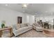 Open-concept living room flows into the kitchen and dining area, featuring hardwood floors and neutral decor at 3537 Crosstrees Ln, Mount Pleasant, SC 29466