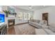 Spacious living room featuring fireplace, large windows, and neutral colored sofa atop an elegant rug at 3537 Crosstrees Ln, Mount Pleasant, SC 29466