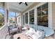 Inviting screened porch with comfortable seating and views of the green backyard and trees at 3537 Crosstrees Ln, Mount Pleasant, SC 29466