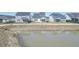 Light blue homes with fences surround a pond in the backyard at 444 Parish Farms Dr, Summerville, SC 29486