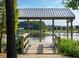 Scenic view of a wooden dock overlooking the lake for relaxation and waterfront enjoyment at 444 Parish Farms Dr, Summerville, SC 29486