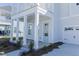 Close-up exterior view of charming two-story home with light blue door and attached two car garage at 444 Parish Farms Dr, Summerville, SC 29486