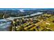 Scenic aerial view capturing a charming neighborhood nestled alongside a tranquil river and expansive green fields at 4715 Highway 165, Meggett, SC 29449