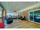 Covered back deck with a ceiling fan provides a comfortable outdoor seating area with brick exterior and railing at 4715 Highway 165, Meggett, SC 29449