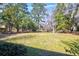 A sprawling backyard offering a serene setting with lush greenery, providing ample space for outdoor activities at 4715 Highway 165, Meggett, SC 29449