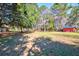 A sprawling backyard with a shed and ample space for outdoor activities, providing a serene setting with lush greenery at 4715 Highway 165, Meggett, SC 29449