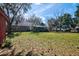 Spacious backyard with mature trees, partial grass coverage, and a serene view of the home's exterior at 4715 Highway 165, Meggett, SC 29449