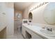 Bright bathroom with tile flooring, a large vanity with double sinks, and abundant lighting and cabinet space at 4715 Highway 165, Meggett, SC 29449