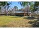 Charming exterior of the home with a welcoming porch, landscaped yard, mature trees, and a well-maintained lawn at 4715 Highway 165, Meggett, SC 29449