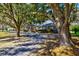 Landscaped brick home with mature trees surrounding the property at 4715 Highway 165, Meggett, SC 29449