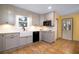 Updated kitchen with gray cabinets, farmhouse sink, and modern appliances, offering a stylish and functional space at 4715 Highway 165, Meggett, SC 29449