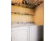 Practical laundry room with washer, dryer, and storage shelving, providing convenience and organization at 4715 Highway 165, Meggett, SC 29449