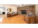 Inviting living room with a brick fireplace and hardwood floors, creating a warm and cozy atmosphere at 4715 Highway 165, Meggett, SC 29449